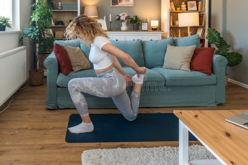 young-female-student-exercising-at-home-to-relieve-back-pain-from-long