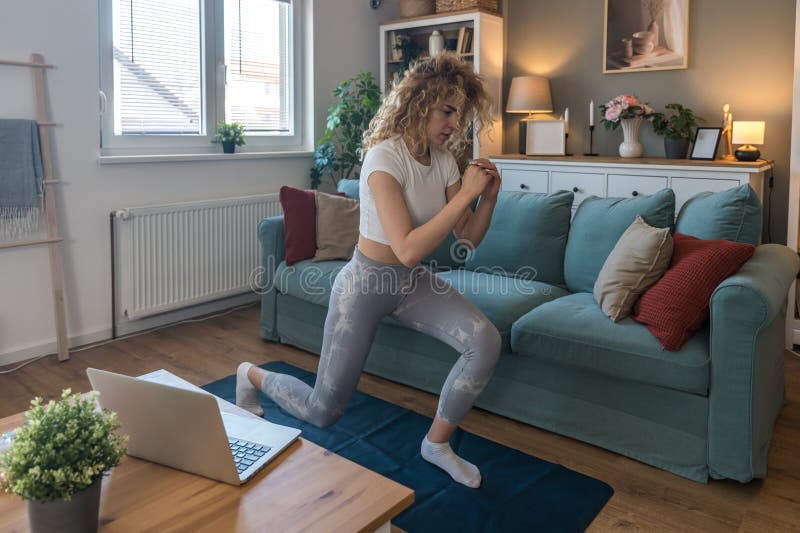 young-female-student-exercising-at-home-to-relieve-back-pain-from-long