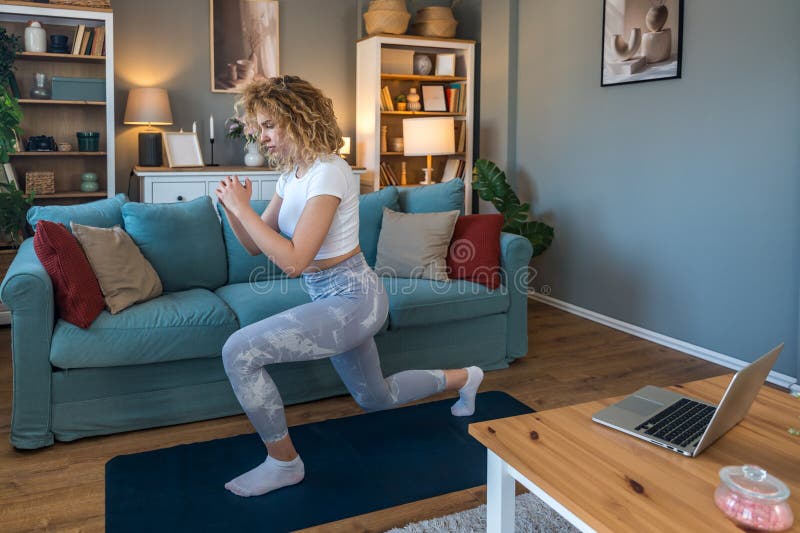 young-female-student-exercising-at-home-to-relieve-back-pain-from-long