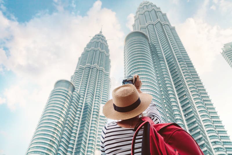Young female tourist making picture shot of two skyscrapers towers in big asian city royalty free stock photos Young female tourist making picture shot of two skyscrapers towers in big asian city royalty free stock photos