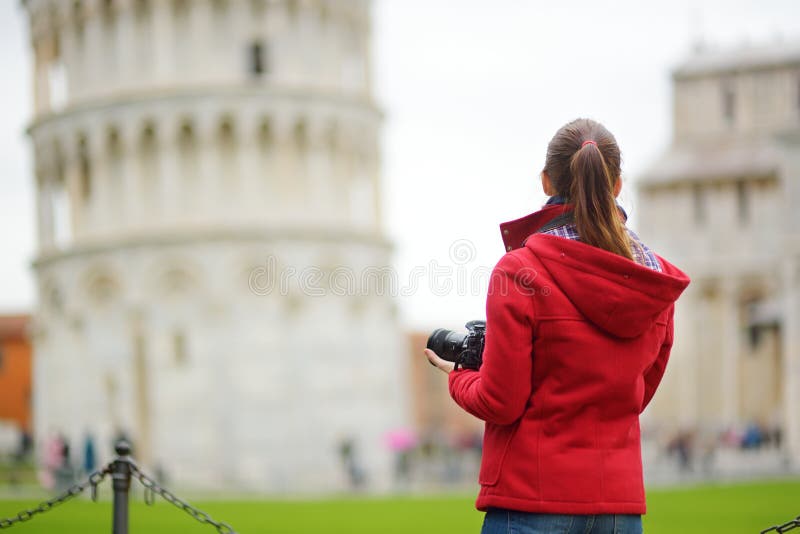 Young female tourist taking photos of the famous Leaning Tower of Pisa royalty free stock photo Young female tourist taking photos of the famous Leaning Tower of Pisa royalty free stock photo