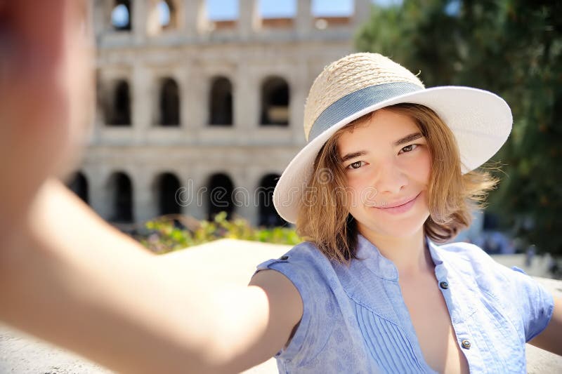 Young female traveler making selfie photo standing the Colosseum in Rome, Italy royalty free stock image Young female traveler making selfie photo standing the Colosseum in Rome, Italy royalty free stock image