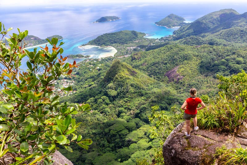 Young female traveller standing at the edge of the cliff, Mahe, Seychelles.