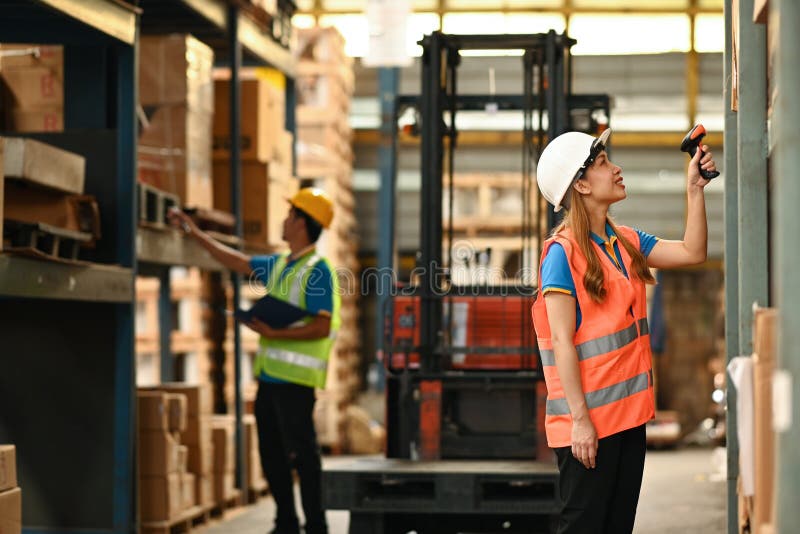 Young Female Warehouse Worker Using Barcode Scanner Checking Stock on