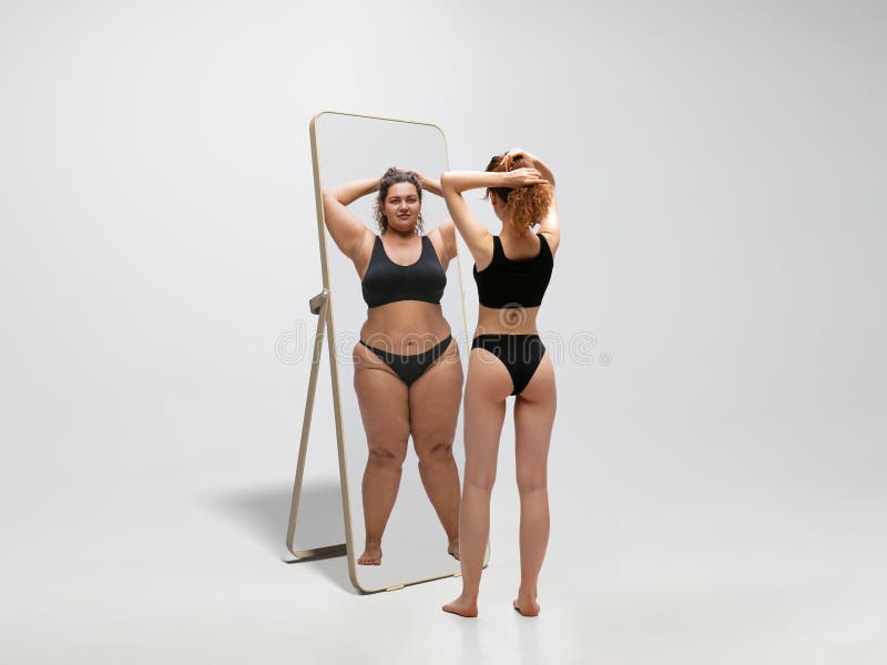 Young Fit, Slim Woman Looking at Fat Girl in Mirror`s Reflection on White  Background Stock Image - Image of like, overweight: 193388683