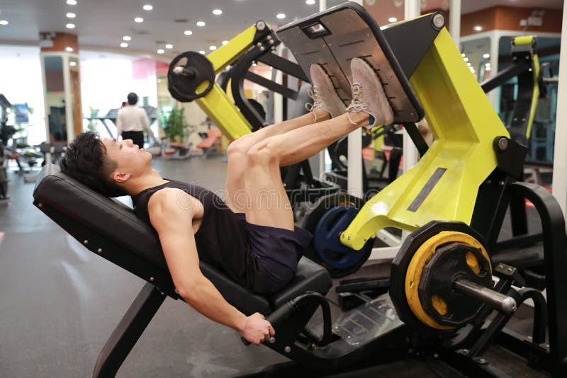 Asian chinese man in gym ï¼ŒFitness sport man Training of leg strength in the gym