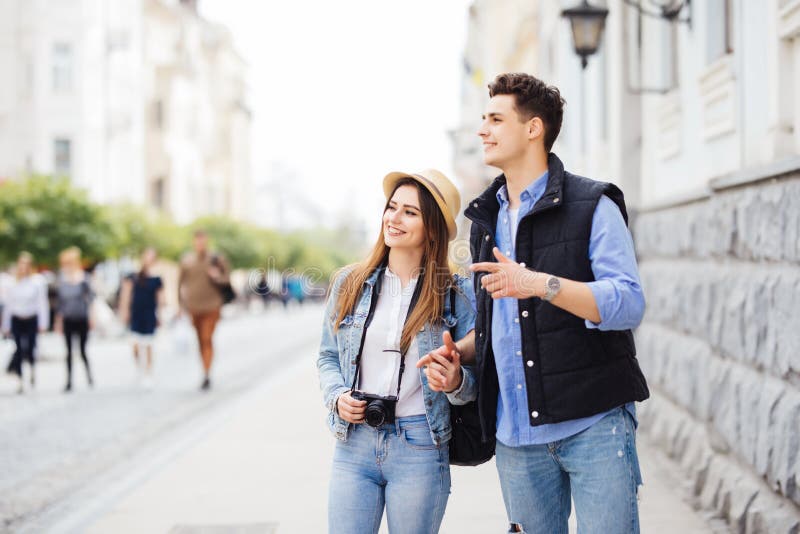 Young freelancing photographers enjoying traveling and backpacking. Young couple with backpack travel new destination stock photography Young freelancing photographers enjoying traveling and backpacking. Young couple with backpack travel new destination stock photography