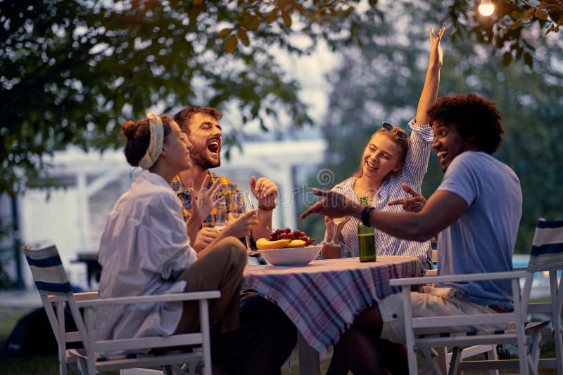 Young friends  party at picnic after sunset