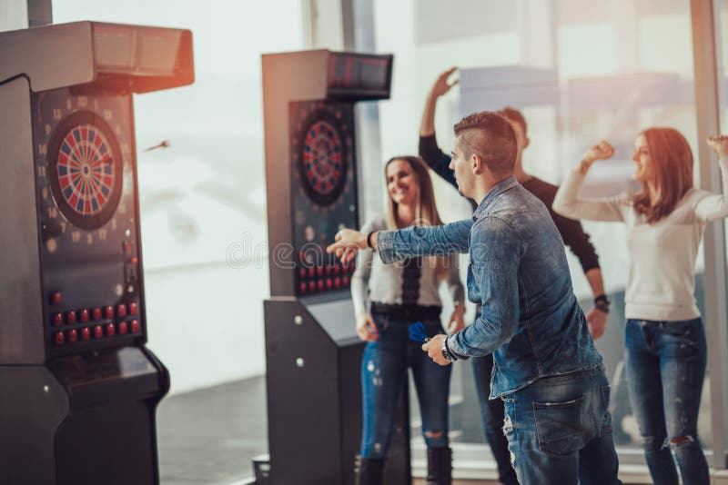 Young friends playing darts stock photos