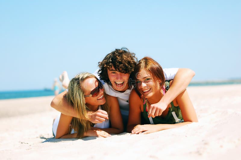 Young friends on the summer beach