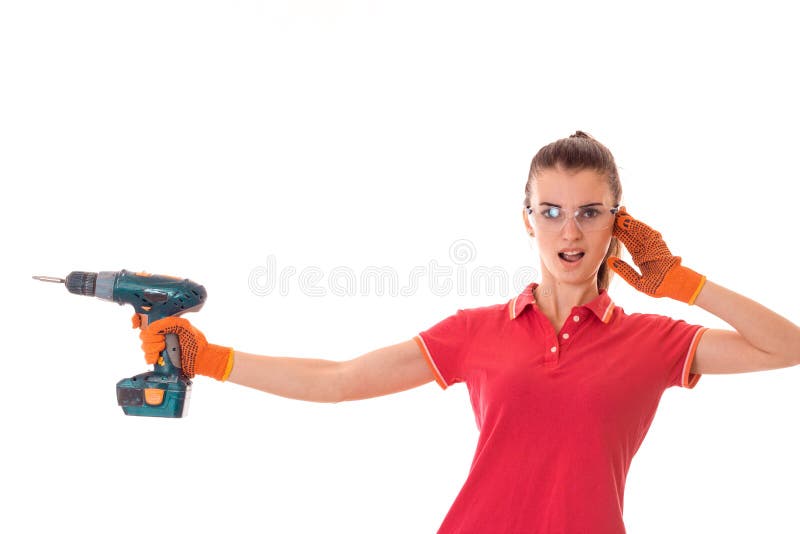 Young funny brunette woman builder in uniform with glasses and drill in her hands make reovations isolated on white stock photography Young funny brunette woman builder in uniform with glasses and drill in her hands make reovations isolated on white stock photography