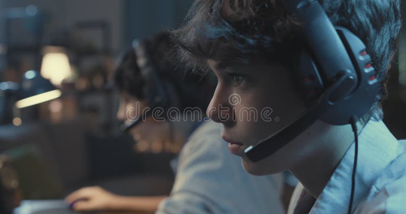 Gamers playing FPS games together at home stock video