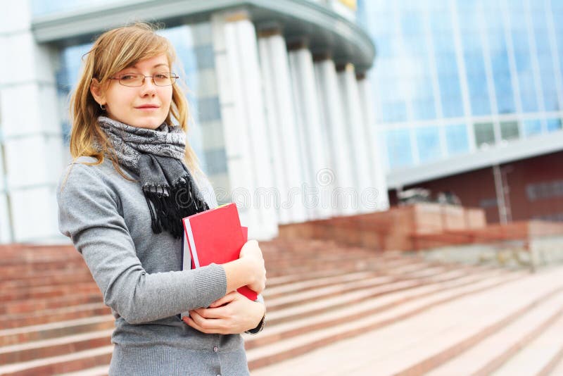 The young girl on a background of modern buildings