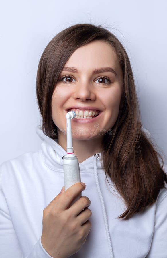 Young Girl With Electric Toothbrush