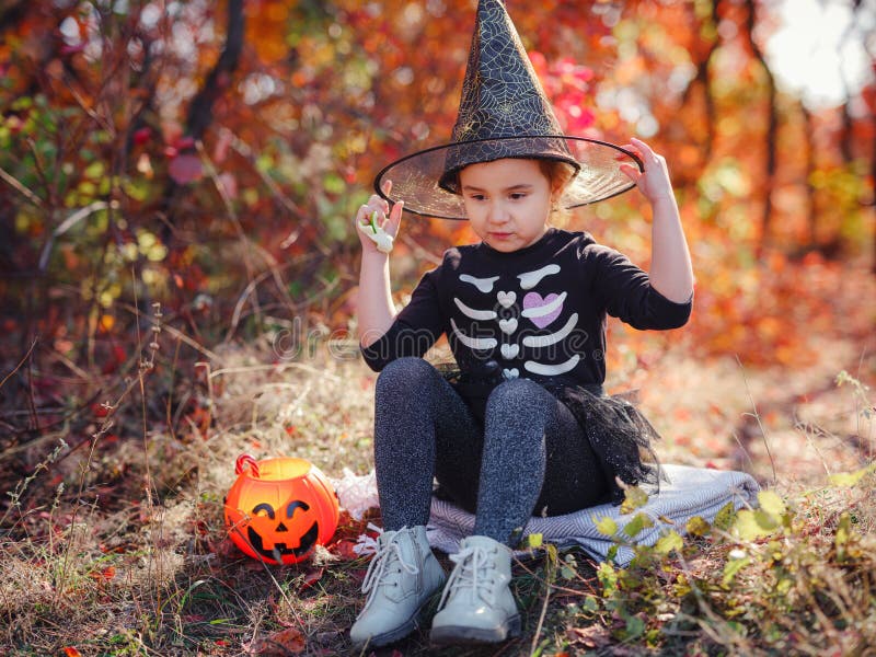 Young Girl in Black Costume Goes Trick or Treating Stock Photo - Image ...
