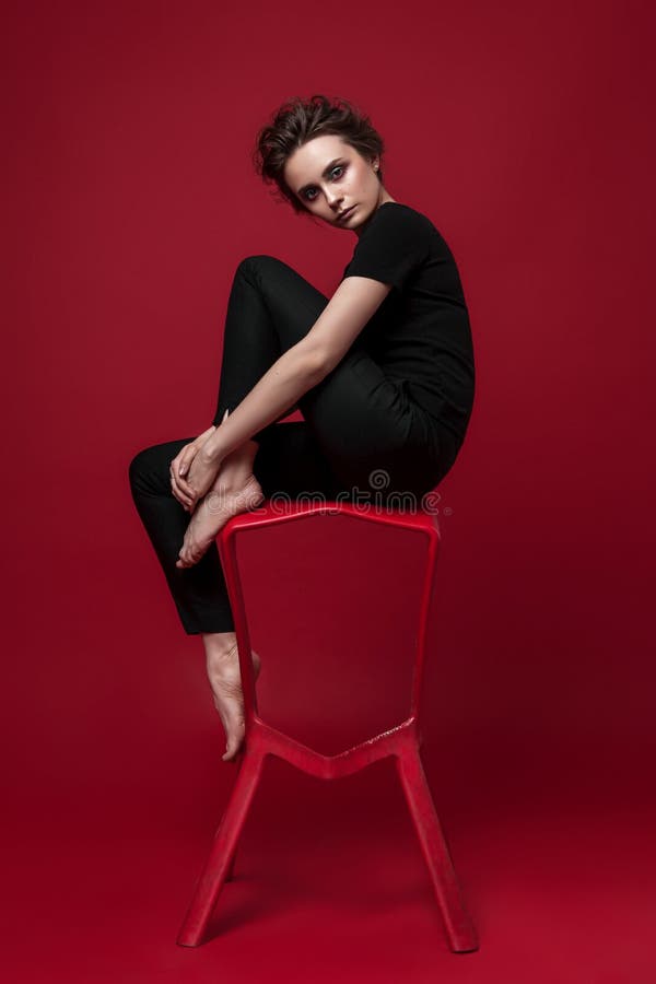 Portrait of Young Girl in Black Suit on Red Background Sitting Pose Stock  Image - Image of hairstyle, style: 117161111