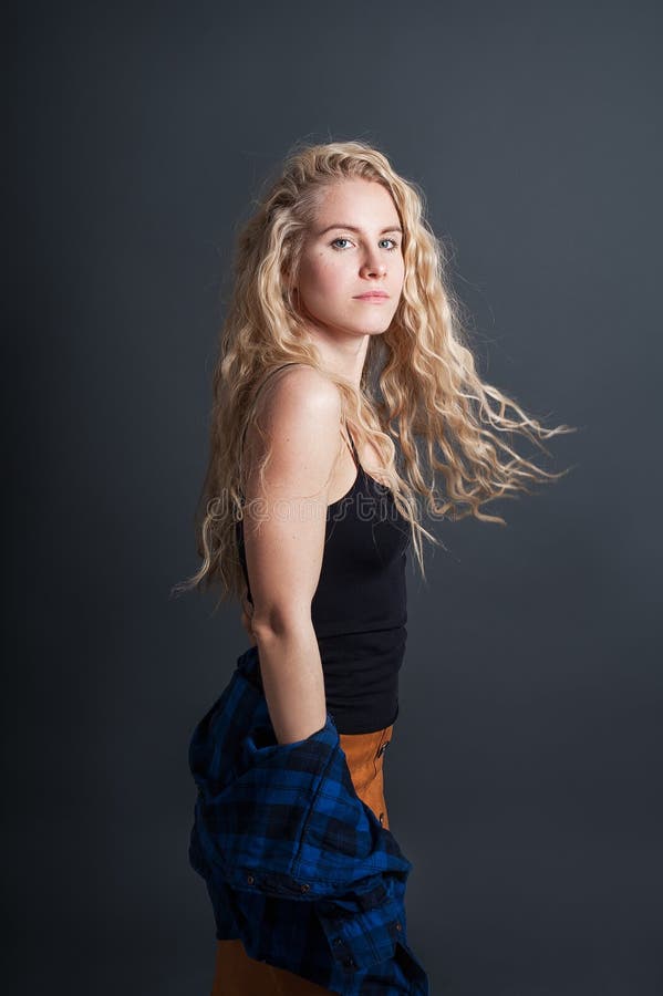 Young girl with blond hair. Studio portrait on dark background. stock photography Young girl with blond hair. Studio portrait on dark background. stock photography