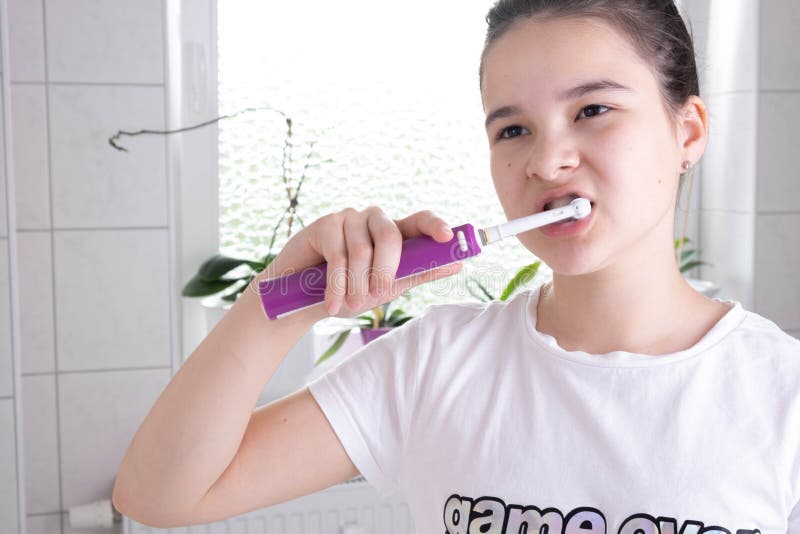 Young Girl With Electric Toothbrush