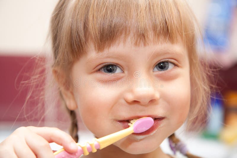 Young girl brushing her teeth