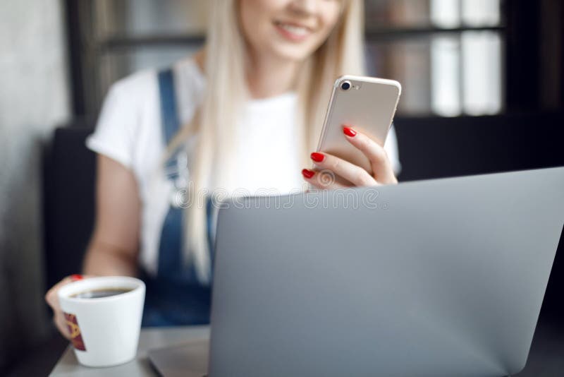 Young girl at cafe drinking coffee and using mobile phone. Online shopping royalty free stock images Young girl at cafe drinking coffee and using mobile phone. Online shopping royalty free stock images