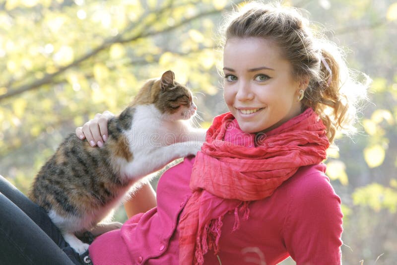 Young girl with cat outdoors