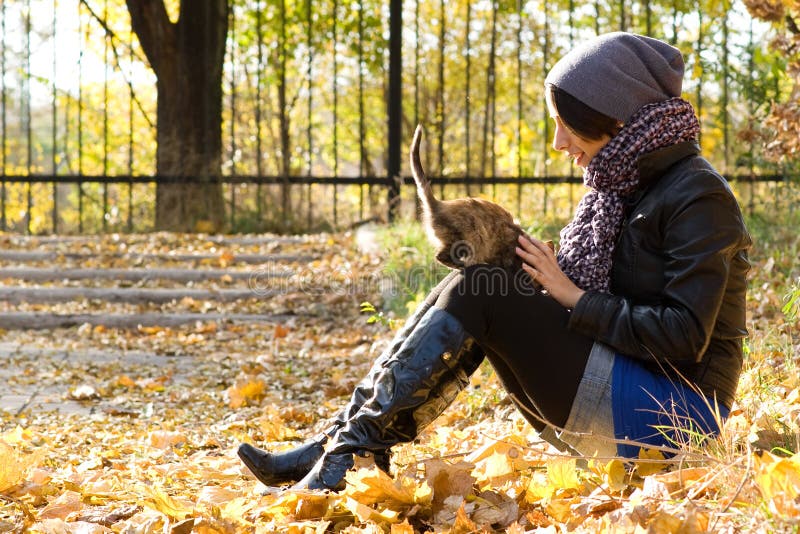 Young girl with a cat outdoors