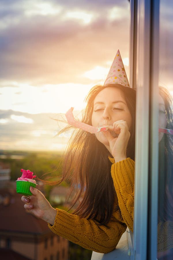 A Young Girl is Celebrating Her Birthday Alone, Leaning Out of the ...
