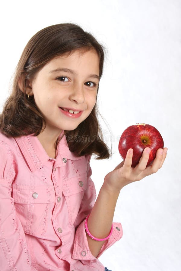 Young girl / child with fresh red apple against white background. Young girl / child with fresh red apple against white background