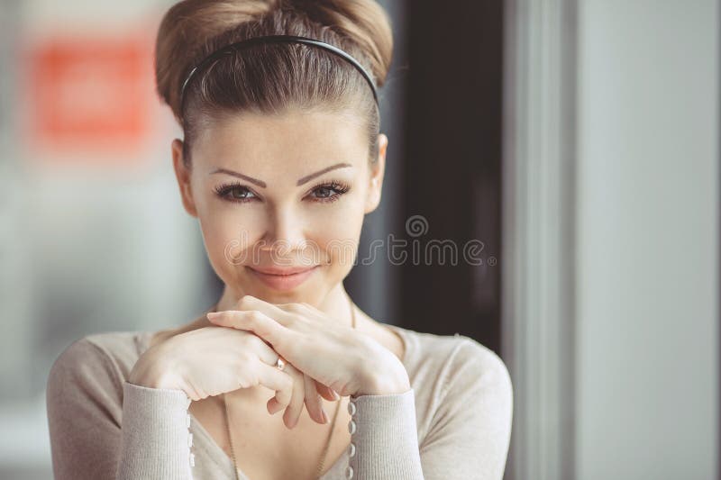 Young girl with a cup of coffee. Focus on the eyes.