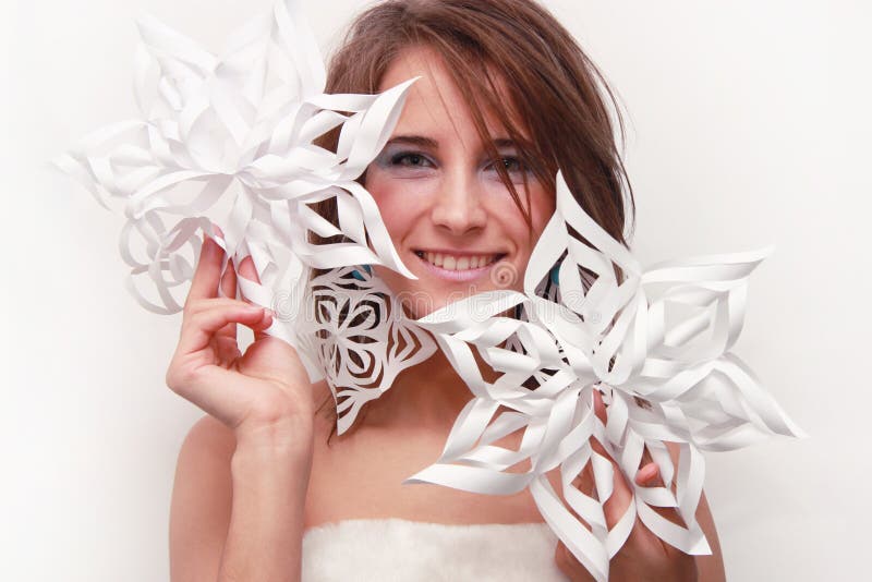 Young girl with cut snowflakes
