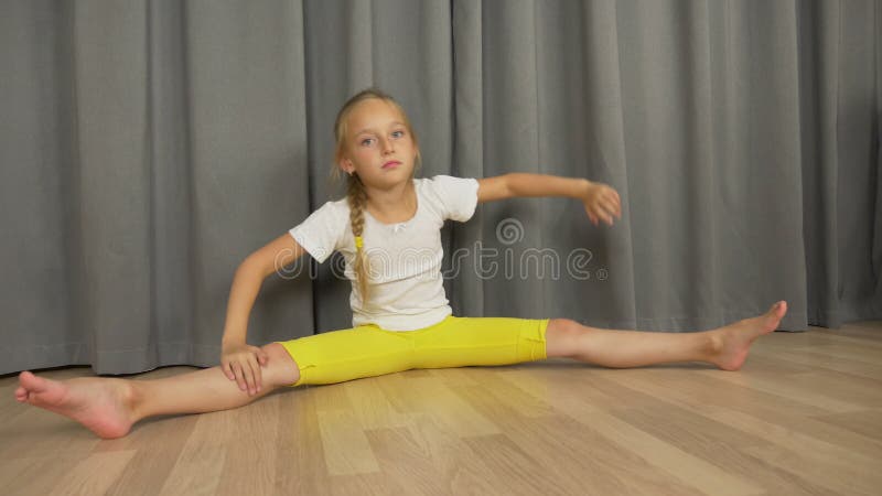 Young Girl Do Split and Stretching at Living Room Indoors. Happy