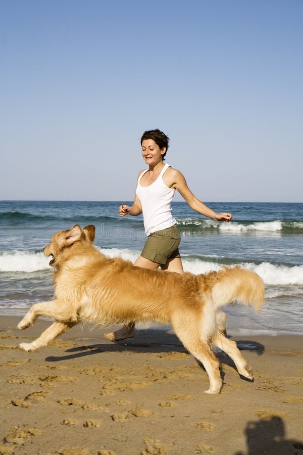 Young girl and dog playing