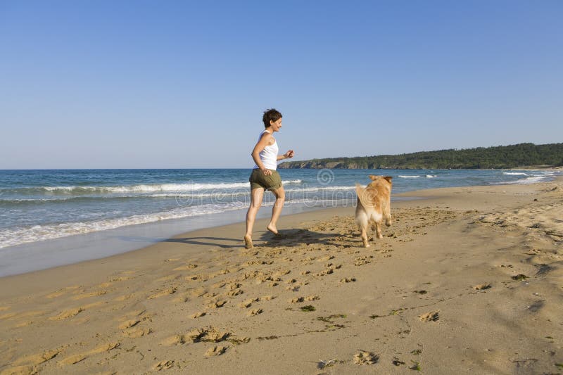 Young girl and dog playing