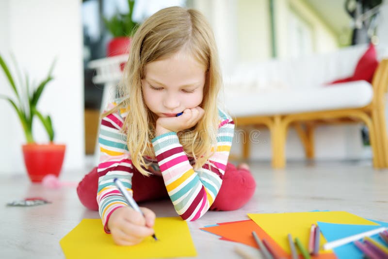 Young girl drawing with colorful pencils at home. Creative kid doing crafts. Education and distance learning for kids. royalty free stock photo Young girl drawing with colorful pencils at home. Creative kid doing crafts. Education and distance learning for kids. royalty free stock photo