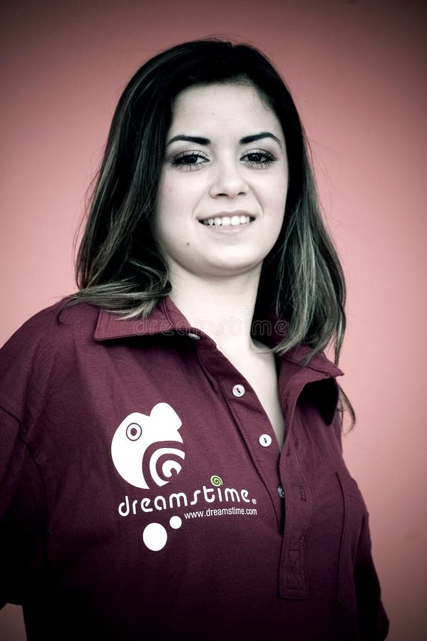 A portrait of a pretty young girl wearing a pullover shirt with the Dreamstime name and logo on it. Color modified. A portrait of a pretty young girl wearing a pullover shirt with the Dreamstime name and logo on it. Color modified.