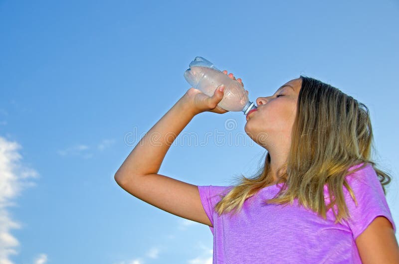 Young Girl Drinking Water From A Bottle Stock Image 