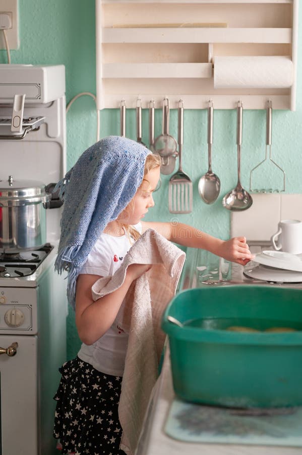 A Young Girl Drying Dishes at a Kitchen Sink Stock Image Image of