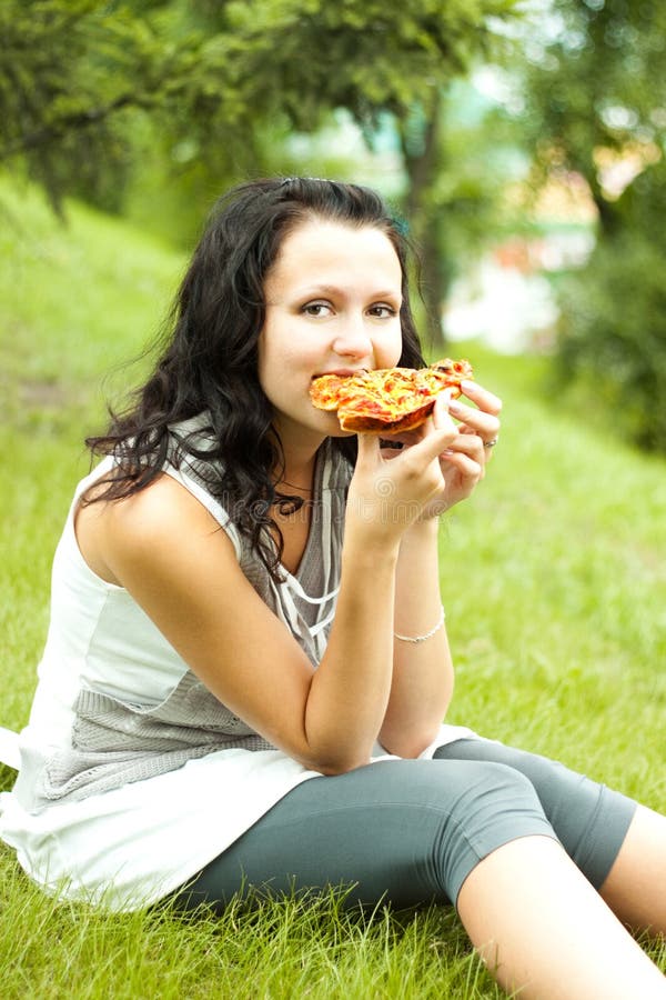 Young girl eat pizza