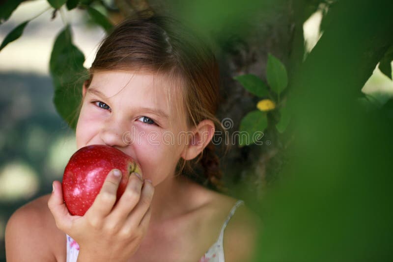 Young girl eating an apple