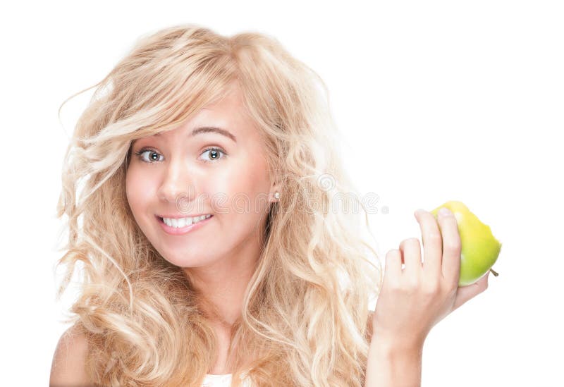 Young girl eating green apple on white background.