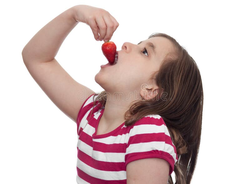 Young girl eating a strawberry