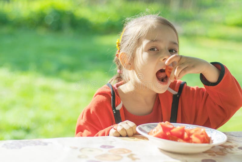 Young Girl eats vegetables