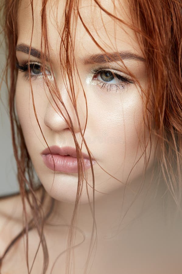 Young Girl in a Gentle Way and Red Hair. Beautiful Model with Shining Skin and Nude Makeup