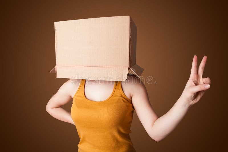 Young Girl Gesturing with a Cardboard Box on His Head Stock Image