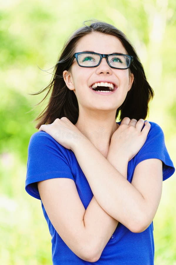 Kid Girl in Glasses and School Uniform with Wireless Headphone Has
