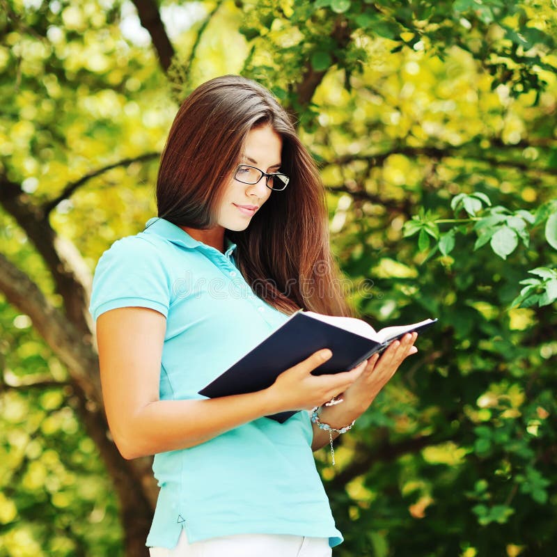 A Young Girl in Glasses with a Book Stock Photo Image of education