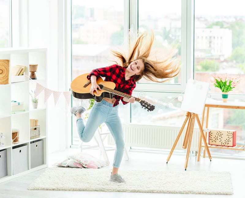 Young girl with guitar in jump