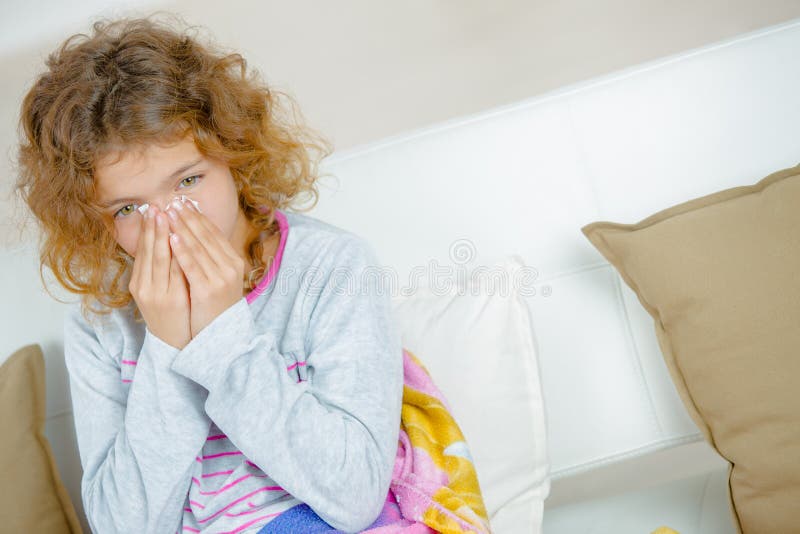 Young girl with hands over nose royalty free stock photography