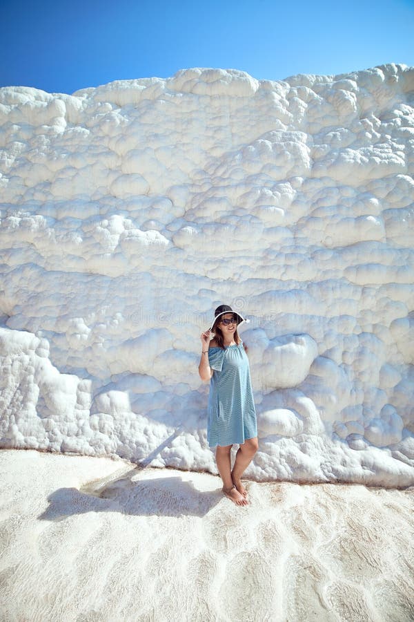 Young girl in hat looking on travertine pools and terraces in Pamukkale. Cotton castle in southwestern Turkey royalty free stock images Young girl in hat looking on travertine pools and terraces in Pamukkale. Cotton castle in southwestern Turkey royalty free stock images