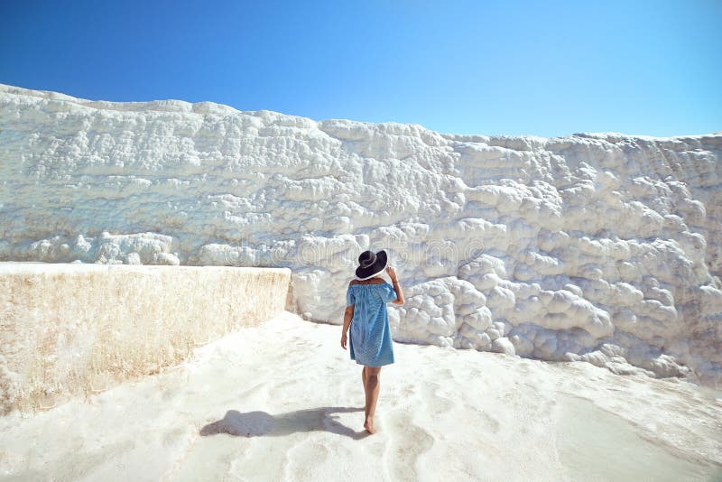 Young girl in hat looking on travertine pools and terraces in Pamukkale. Cotton castle in southwestern Turkey royalty free stock images Young girl in hat looking on travertine pools and terraces in Pamukkale. Cotton castle in southwestern Turkey royalty free stock images